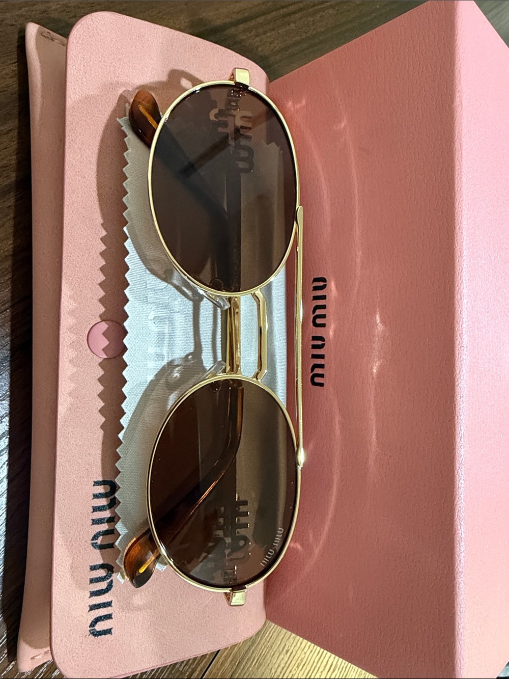 Woman Miu Miu Gold Frame Sunglasses with Brown Lenses